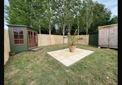 a potted plant in a yard next to a fence at Hinton land glampsite in Peterchurch