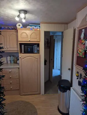 a kitchen with a microwave on top of a counter at Aberystwyth holiday village walking distance to beach, town great outside space parking next to property in Aberystwyth