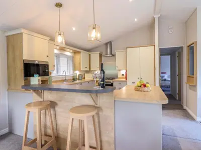 a kitchen with a island with two bar stools at The Owlet in Llanidloes