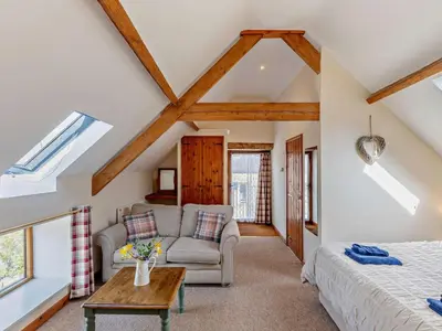 a bedroom with a bed and a couch and a table at 2 Bed in Craven Arms oc-96046 in Tugford