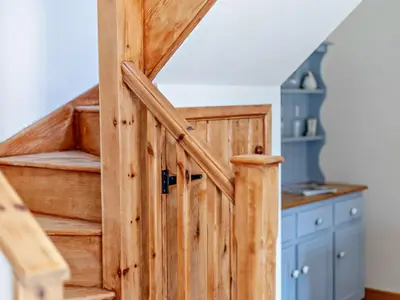 a wooden staircase in a home with a wooden door at 2 Bed in Craven Arms oc-96046 in Tugford