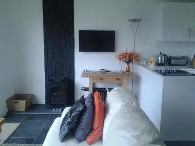 a living room with a couch with pillows on it at Parkway Chalet - Pennal, Powys, Wales nr Aberdovey in Pennal