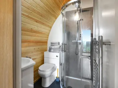 a bathroom with a toilet and a shower at Luna Holiday Pod - Uk48590 in Church Stretton