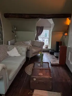 a living room with a couch and a table at The Little Laura Ashley House in Machynlleth