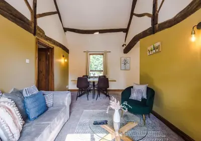 a living room with a couch and a table at Peaceful Barn Near Cader Idris in Dolgellau