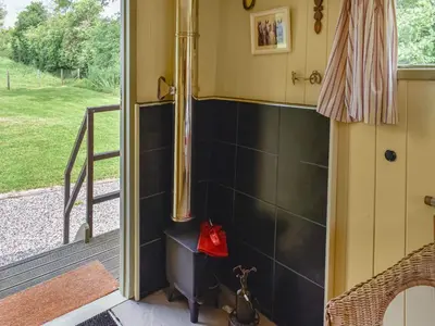 a bathroom with a shower with black tiles at Tilly - Uk49798 in Brecon