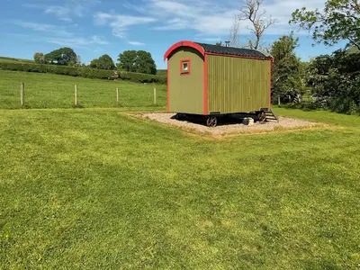 a smallshed sitting in the middle of a field at Brown Hare - Uk49799 in Brecon
