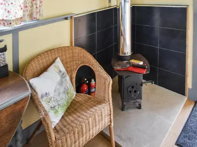 a room with a chair and a wood stove at Brown Hare - Uk49799 in Brecon