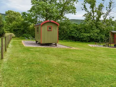 a smallshed sitting in the middle of a grass field at Sweet Briar - Uk49797 in Brecon