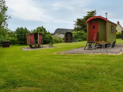 a park with two small houses and a picnic table at Sweet Briar - Uk49797 in Brecon