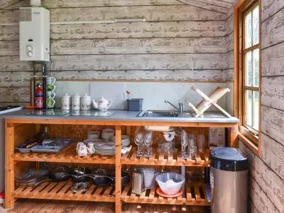 a kitchen with a sink and a shelf with dishes at Sweet Briar - Uk49797 in Brecon