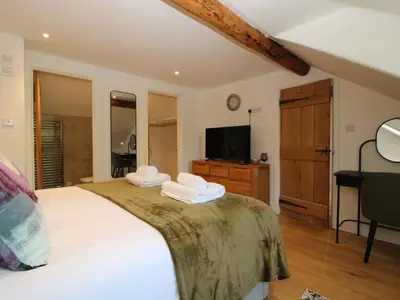 a bedroom with a large bed with towels on it at 10 Bridge Street in Craven Arms