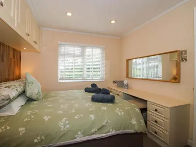 a bedroom with a bed with a desk and a mirror at Dunromin in Montgomery