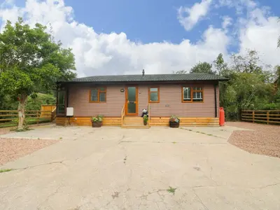 a small house with a driveway in front of it at Dunromin in Montgomery