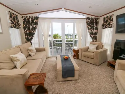 a living room with a couch and a table at Ty Seren in New Quay