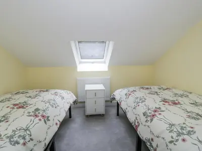 two beds in a attic bedroom with a skylight at Frongoch Old Power House in Dolgellau