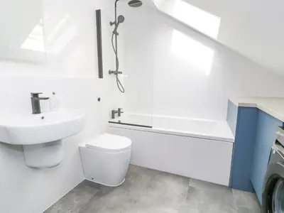 a white bathroom with a toilet and a sink at Frongoch Old Power House in Dolgellau