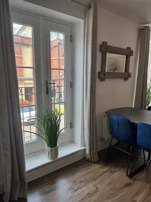 a dining room with a table and a window at Town centre abode with gated parking in Shrewsbury