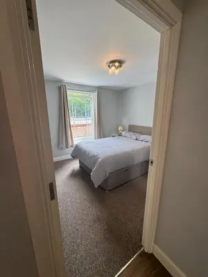 a bedroom with a bed and a window at Town centre abode with gated parking in Shrewsbury
