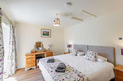 a bedroom with a bed and a desk with a television at 2 Bed in Llanarmon Dyffryn Ceiriog oc-b31110 in Llanarmon Dyffryn-Ceiriog
