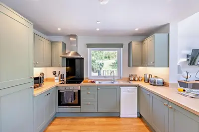a kitchen with blue cabinets and a sink at 2 Bed in Llanarmon Dyffryn Ceiriog oc-b31110 in Llanarmon Dyffryn-Ceiriog