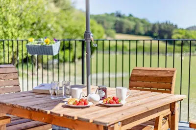 a wooden table with plates of fruit on it at 2 Bed in Llanarmon Dyffryn Ceiriog oc-b31110 in Llanarmon Dyffryn-Ceiriog