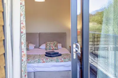 a bed in a small room with a balcony at 2 Bed in Llanarmon Dyffryn Ceiriog oc-b31110 in Llanarmon Dyffryn-Ceiriog