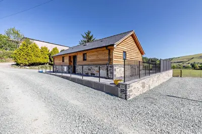 a house on the side of a gravel road at 2 Bed in Llanarmon Dyffryn Ceiriog oc-b31110 in Llanarmon Dyffryn-Ceiriog