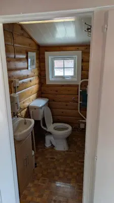 a small bathroom with a toilet and a sink at Happy Place LogCabin in Trawsfynydd