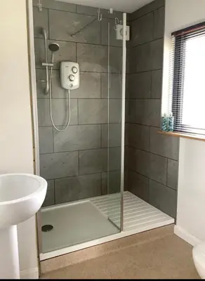 a shower with a glass door in a bathroom at Little Hare Lodge - Near Ludlow in Lane to Richards Castle