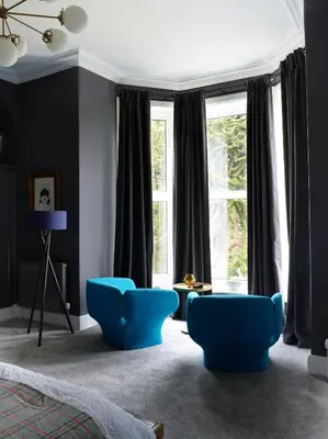 a bedroom with blue chairs and a large window at The Royston in Llanbrynmair