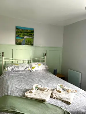 a bed with two towels on top of it at The Old Ford inn in Llanhamlach