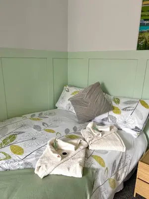 a bed with towels and pillows on it at The Old Ford inn in Llanhamlach