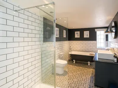 a bathroom with a shower and a toilet and a tub at The Loft - a stylish 2-bed in prime central location - Pass the Keys in Shrewsbury