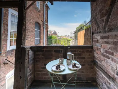 a patio with a white table with two cups on it at The Loft - a stylish 2-bed in prime central location - Pass the Keys in Shrewsbury