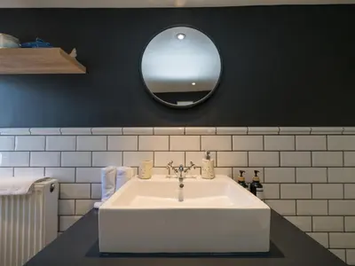 a bathroom with a white sink and a mirror at The Loft - a stylish 2-bed in prime central location - Pass the Keys in Shrewsbury