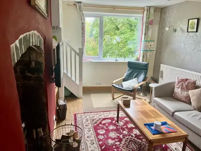 a living room with a couch and a table at Severn Up in Newtown