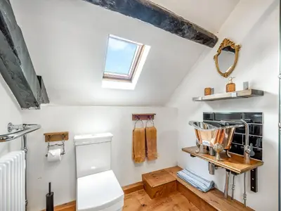 a bathroom with a toilet and a window at Coach House - Uk49793 in Cribyn