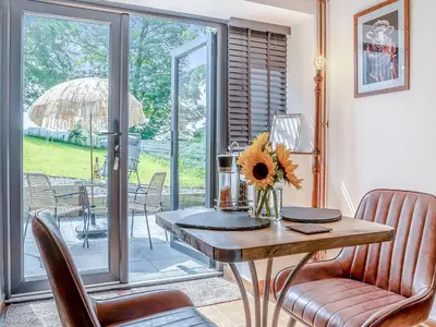 a dining room with a table and chairs and a patio at Sheep Shed - Uk49794 in Cribyn