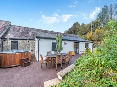 a patio with a table and chairs and a hot tub at Shire - Uk49791 in Cribyn