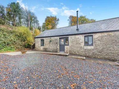 a stone house with a driveway in front of it at Shire - Uk49791 in Cribyn