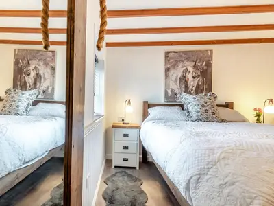 two twin beds in a bedroom with white walls at Shire - Uk49791 in Cribyn