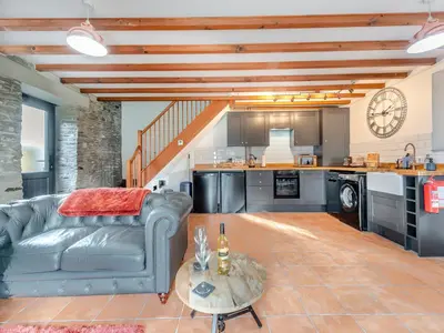 a living room with a couch and a table at Cwtch Honey - Uk49792 in Cribyn