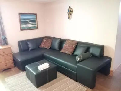 a living room with a blue couch with pillows at Chandler Ranch Llandovery Cynghordy in Cynghordy