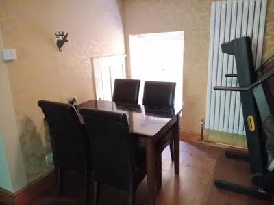 a dining room table with black chairs and a window at Chandler Ranch Llandovery Cynghordy in Cynghordy