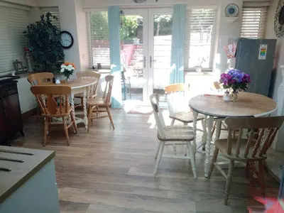 a kitchen with two tables and chairs in a room at Cosy Rural Gilbert Hights Llandovery Cynghordy in Cynghordy