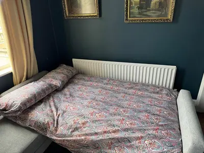 a bedroom with a bed with a comforter on it at English Bridge Court in Shrewsbury