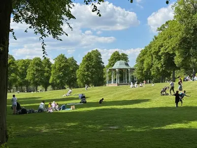 a group of people sitting in a park with a gazebo at English Bridge Court in Shrewsbury
