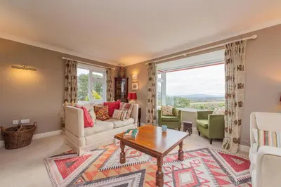 a living room with a couch and a table at Pear Tree Cottage in Shrewsbury