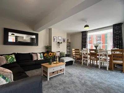 a living room with a couch and a dining room at Llangollen High Street 4 bedrooms Sleeps 12 in Llangollen